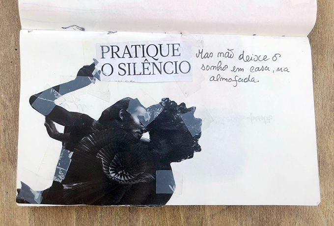 Página com colagem em preto e texto manuscrito